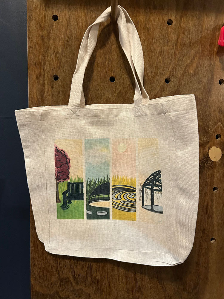 A a large tote bag with a colorful illustration of Fromtier Park