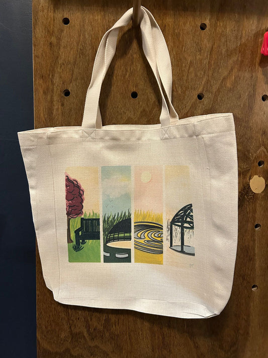 A a large tote bag with a colorful illustration of Fromtier Park