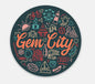 A round decal with colorful line art of popular Erie sites.
