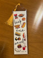 Bookmark in vinyl sleeve with keep Erie weird and drawings of popular Erie snacks 